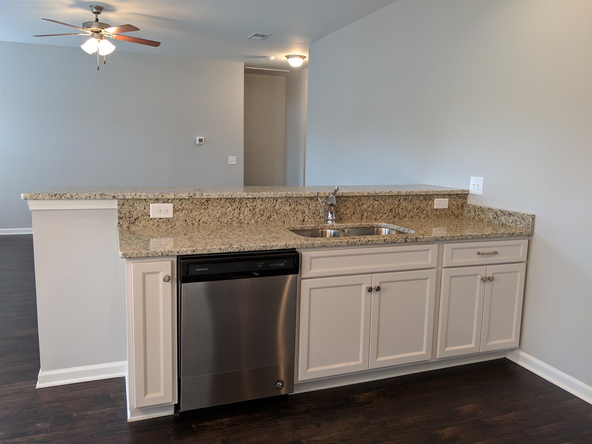 709 Mitscher Drive Spring Hill, TN 37174 - Photo 18 of 27 a kitchen with granite countertop white cabinets and a stove