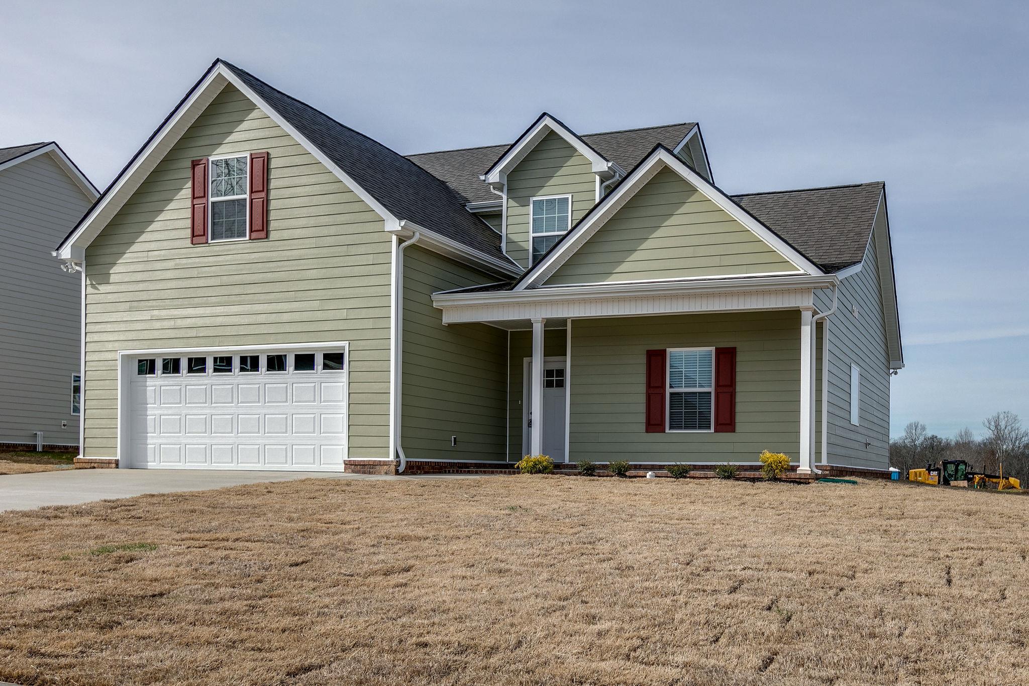 709 Mitscher Drive Spring Hill, TN 37174 - Photo 2 of 27 a front view of a house with a yard and garage