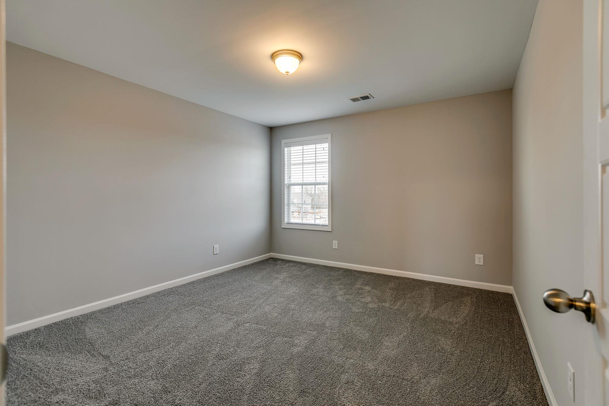 709 Mitscher Drive Spring Hill, TN 37174 - Photo 19 of 27 an empty room with windows