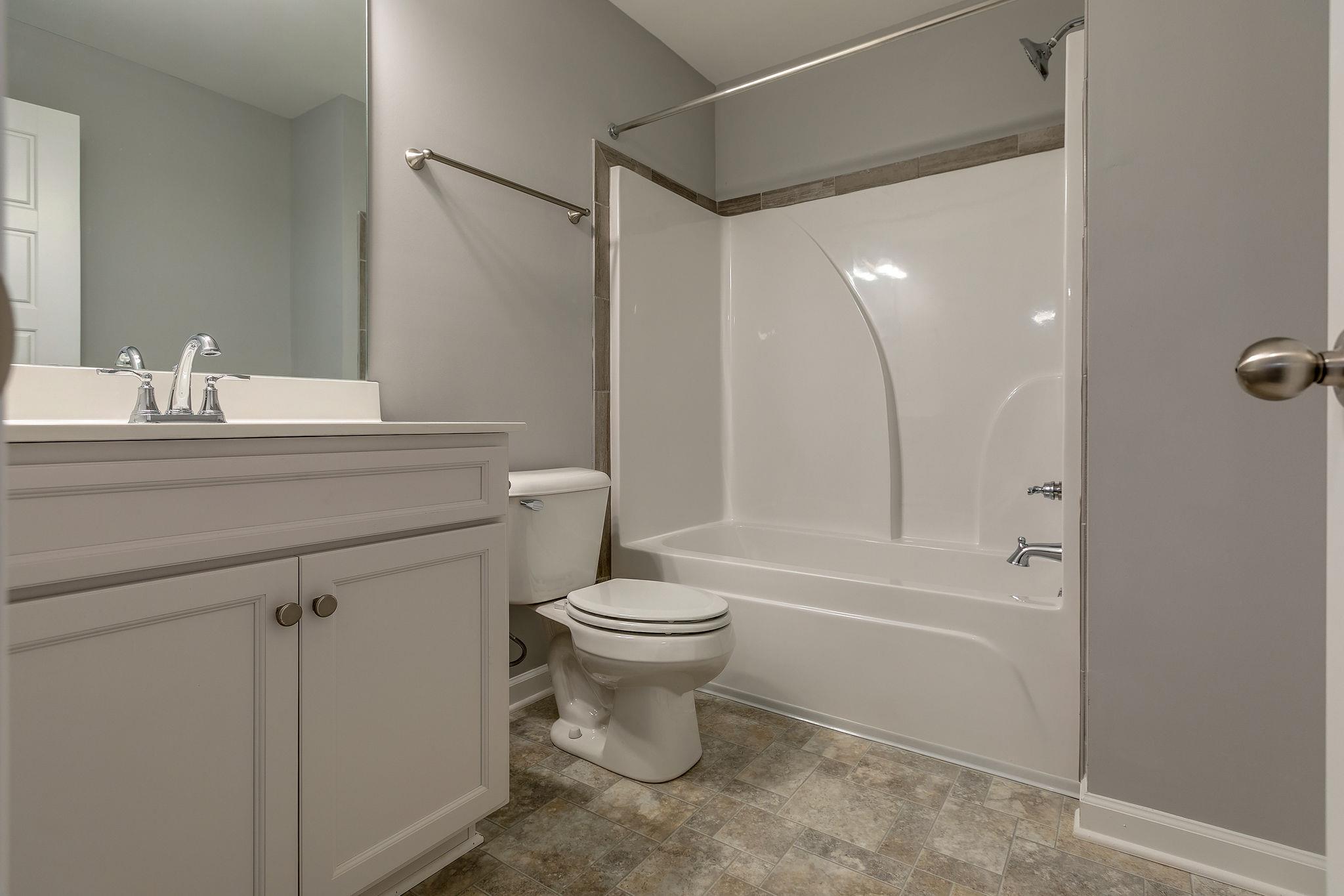 709 Mitscher Drive Spring Hill, TN 37174 - Photo 21 of 27 a bathroom with a sink toilet and shower