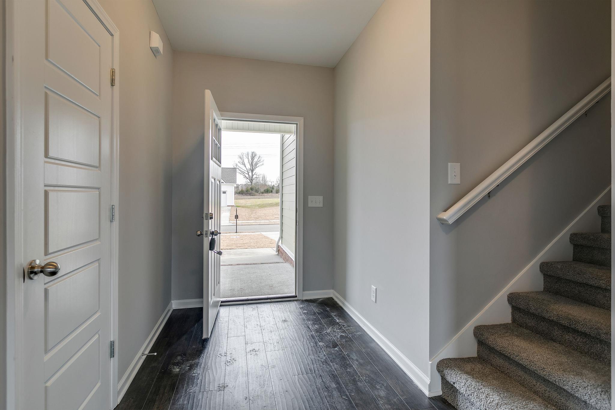 709 Mitscher Drive Spring Hill, TN 37174 - Photo 4 of 27 a view of a hallway with wooden floor and entryway