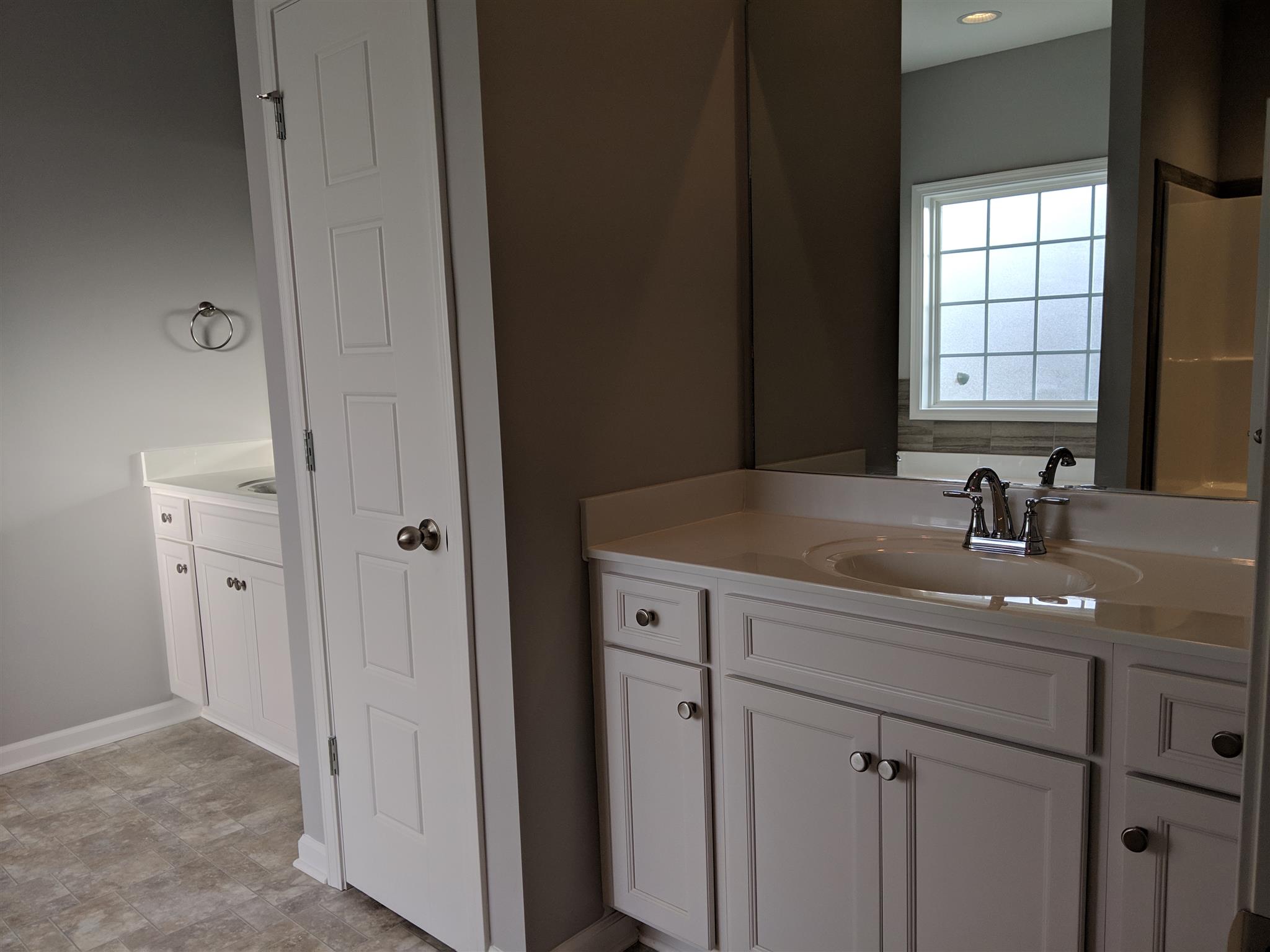709 Mitscher Drive Spring Hill, TN 37174 - Photo 8 of 27 a bathroom with a granite countertop sink a mirror and a window