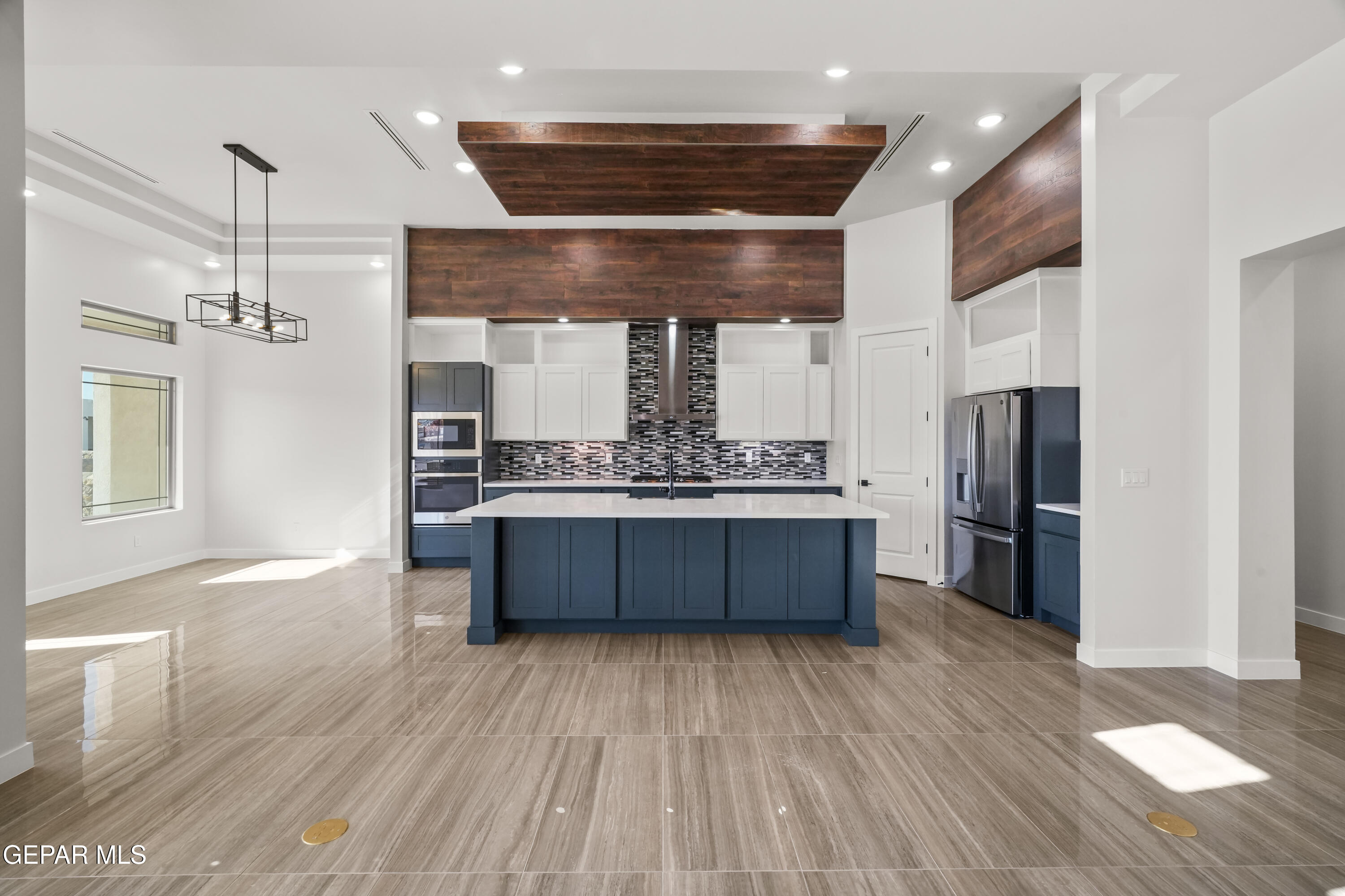 360 Rio De Jazmin Circle El Paso, TX 79932 - Photo 13 of 66 a kitchen with stainless steel appliances kitchen island wooden floors granite counter tops and a window