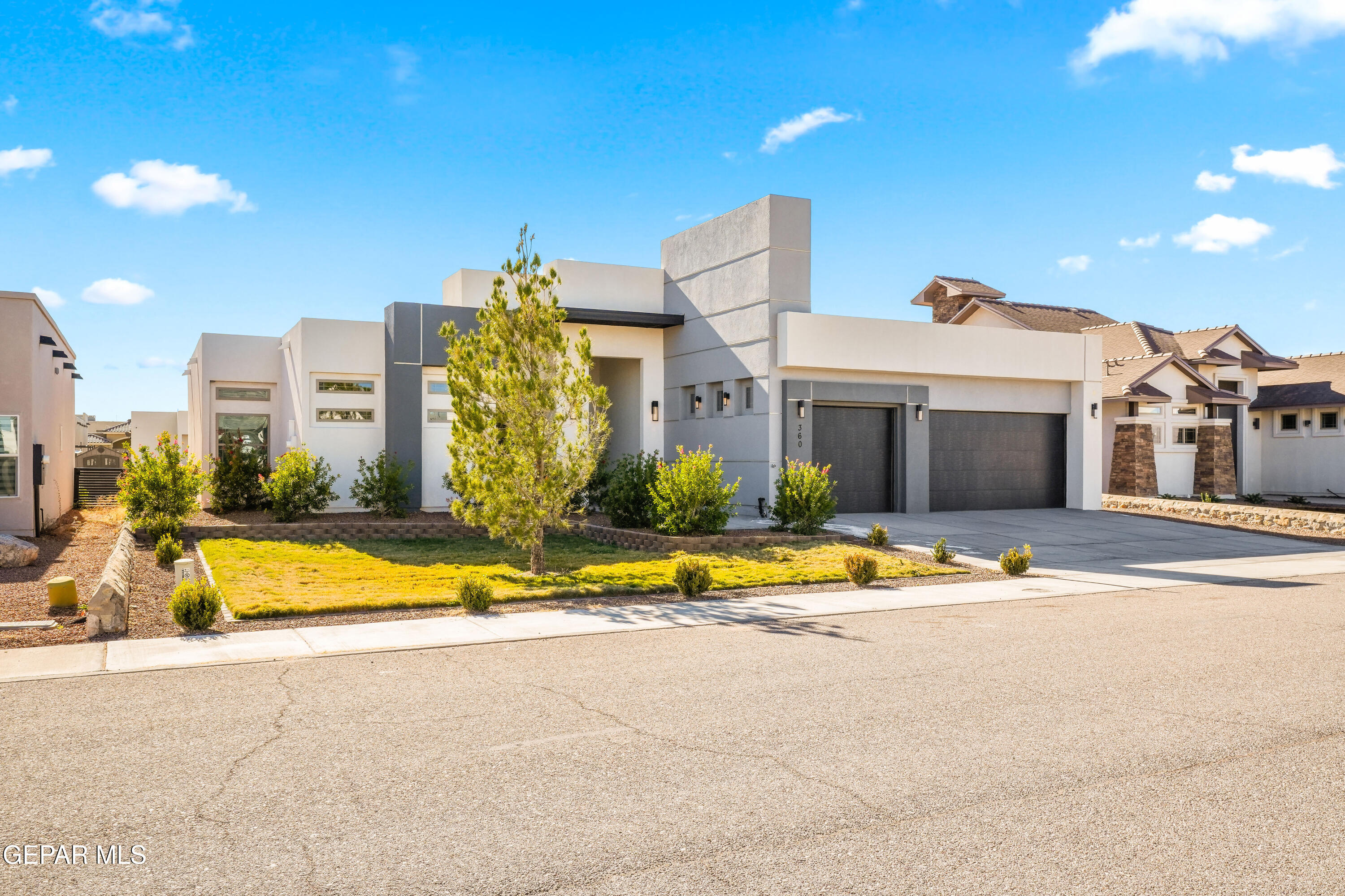 360 Rio De Jazmin Circle El Paso, TX 79932 - Photo 2 of 66 a view of a white building with a swimming pool and a yard