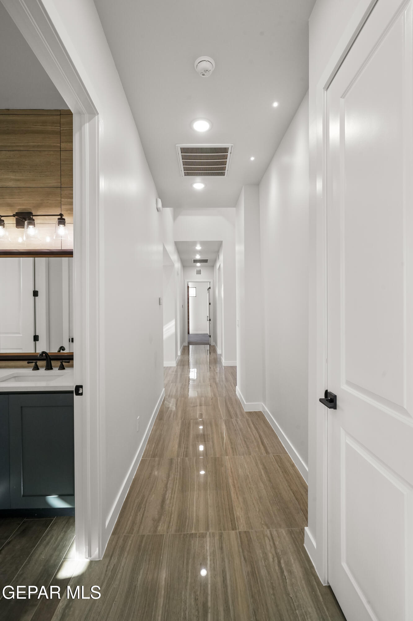 360 Rio De Jazmin Circle El Paso, TX 79932 - Photo 25 of 66 a view of a hallway with wooden floor and a bathroom