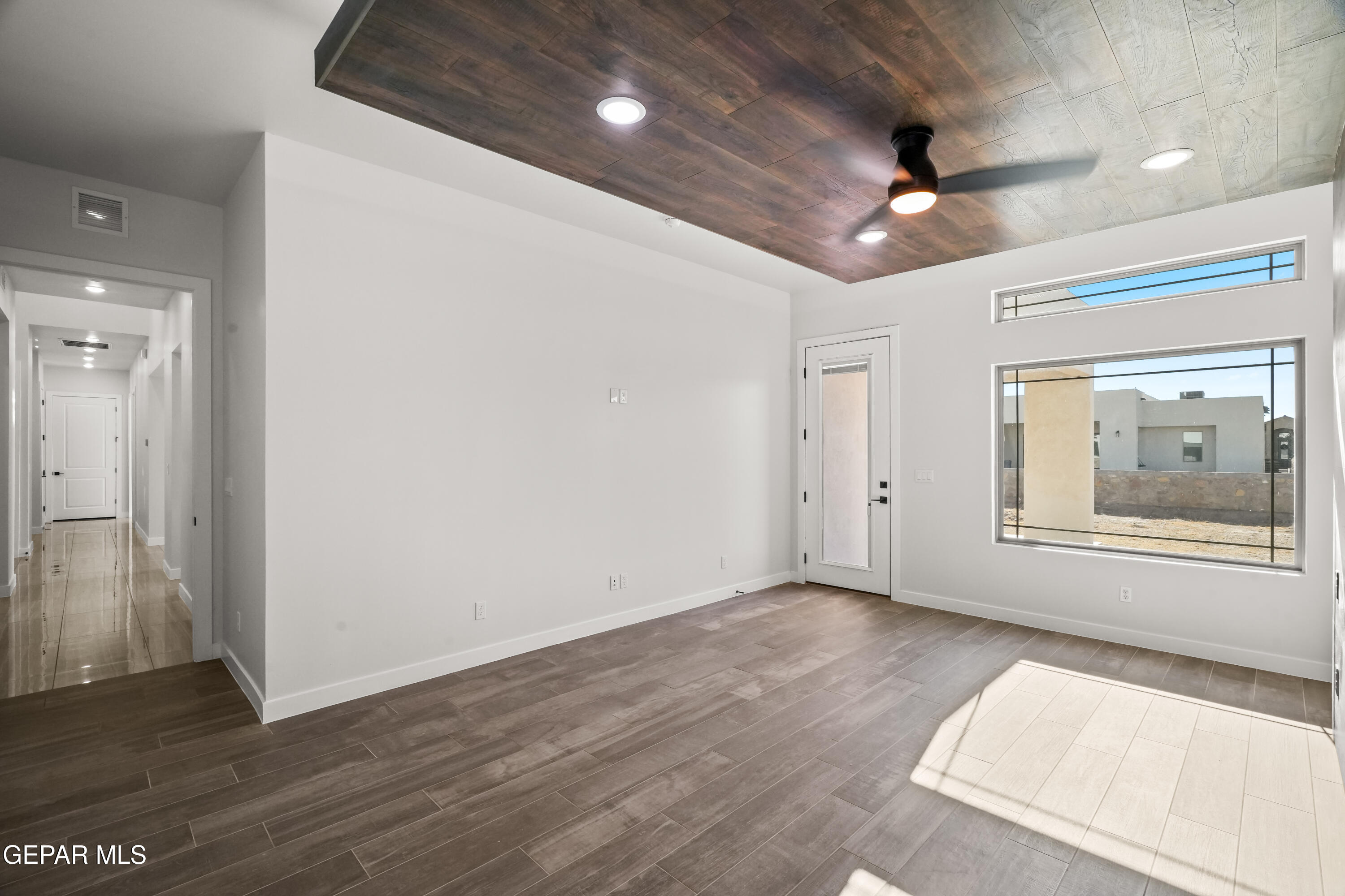 360 Rio De Jazmin Circle El Paso, TX 79932 - Photo 29 of 66 a view of an empty room with wooden floor and a ceiling fan