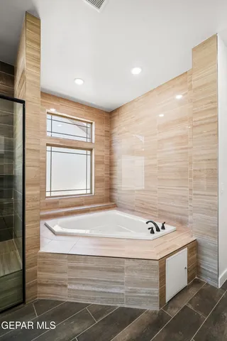 a view of a room with wooden floor a ceiling fan and window