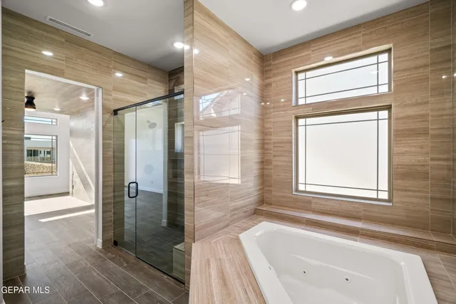 a bathroom with a bathtub and a shower