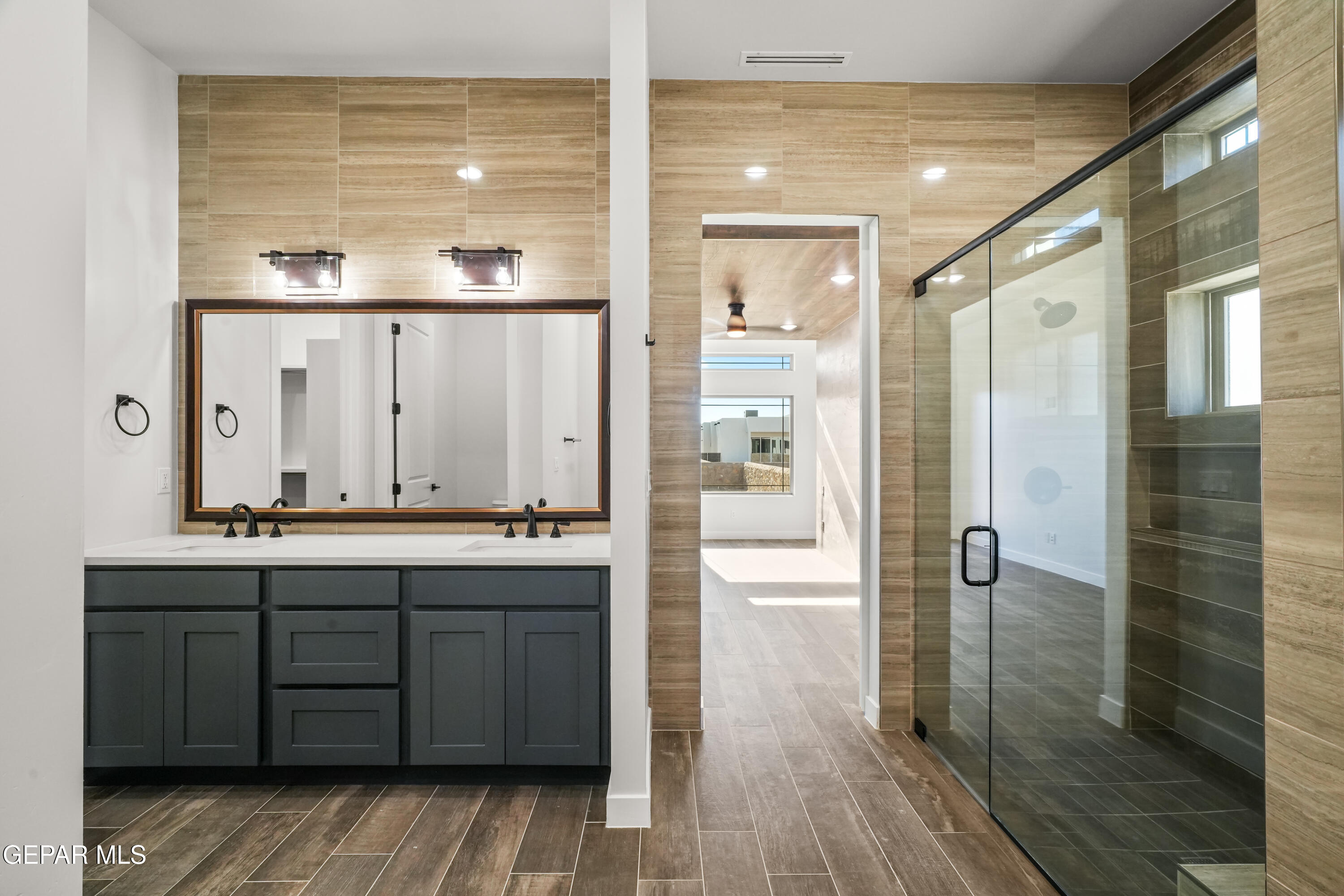 360 Rio De Jazmin Circle El Paso, TX 79932 - Photo 35 of 66 a bathroom with a double vanity sink and mirror