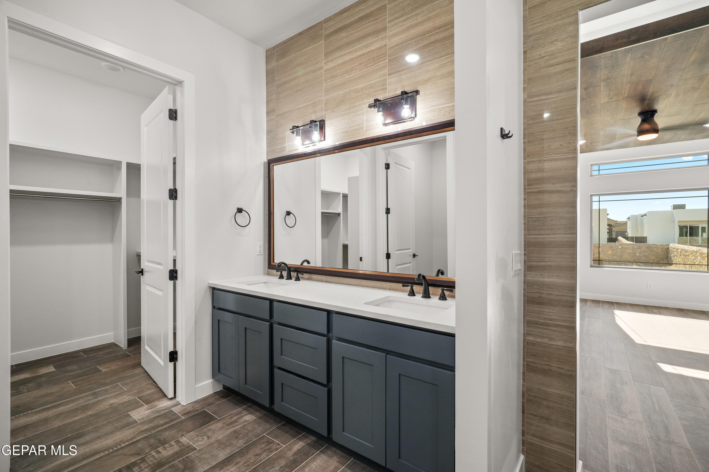 360 Rio De Jazmin Circle El Paso, TX 79932 - Photo 36 of 66 a bathroom with a double vanity sink and mirror
