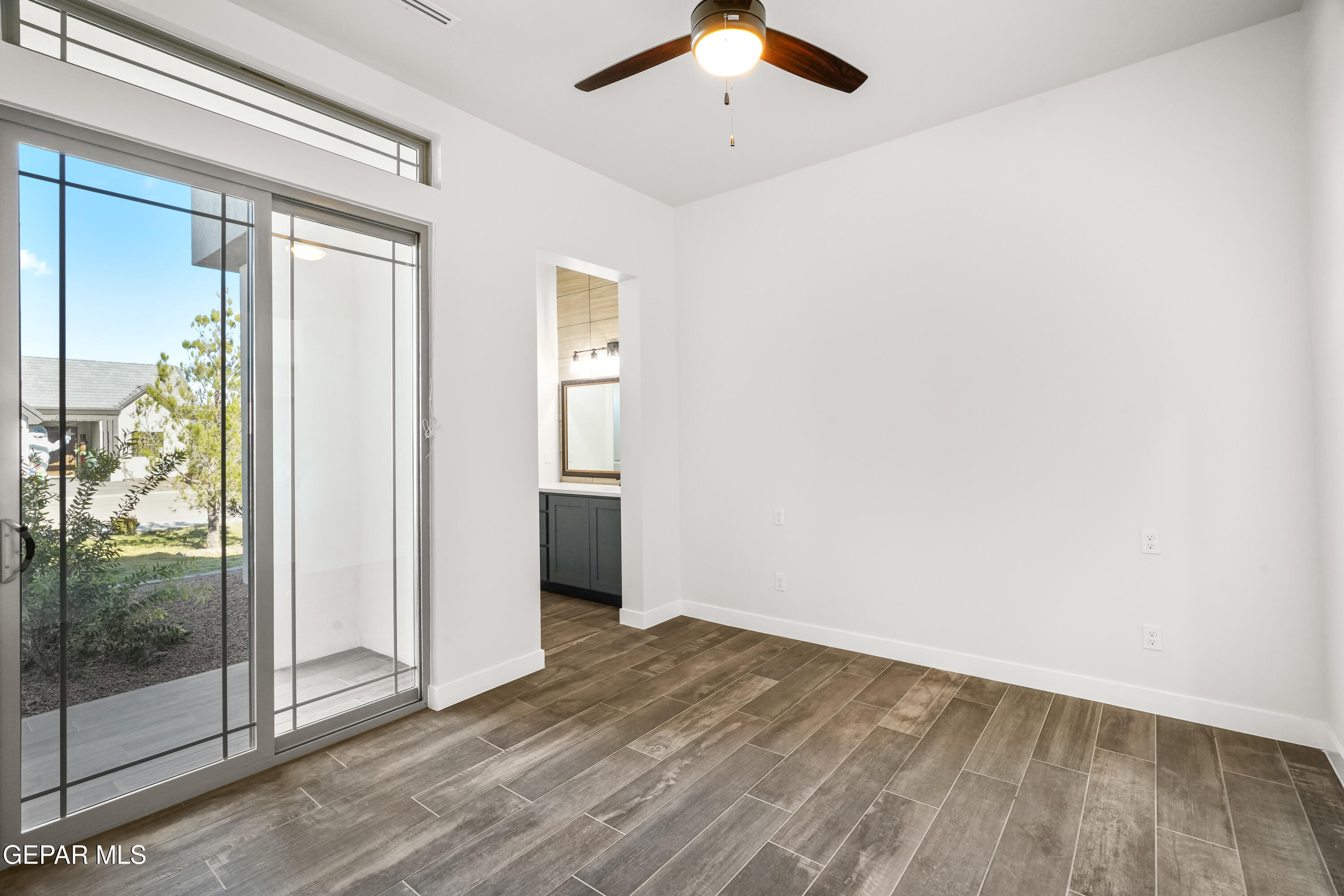 360 Rio De Jazmin Circle El Paso, TX 79932 - Photo 39 of 66 a view of a room with wooden floor a ceiling fan and window