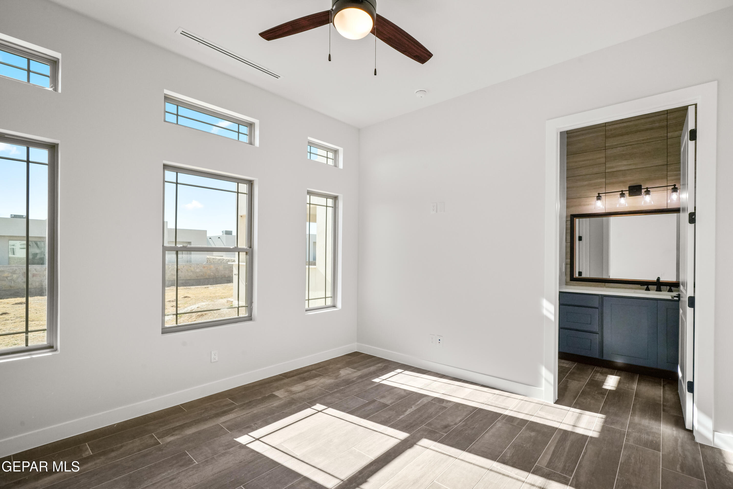 360 Rio De Jazmin Circle El Paso, TX 79932 - Photo 44 of 66 a view of an empty room with window and wooden floor