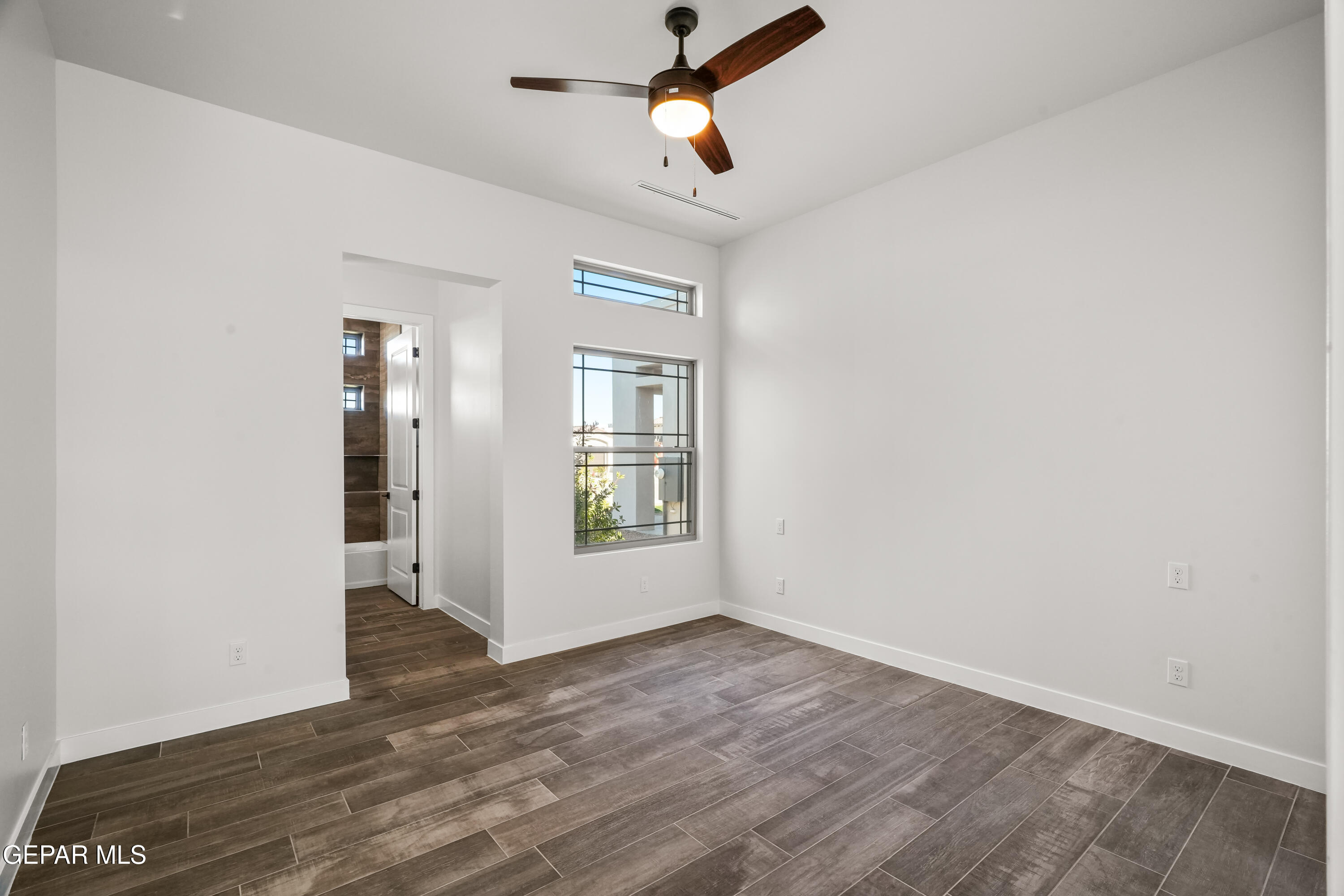 360 Rio De Jazmin Circle El Paso, TX 79932 - Photo 46 of 66 an empty room with wooden floor ceiling fan and windows