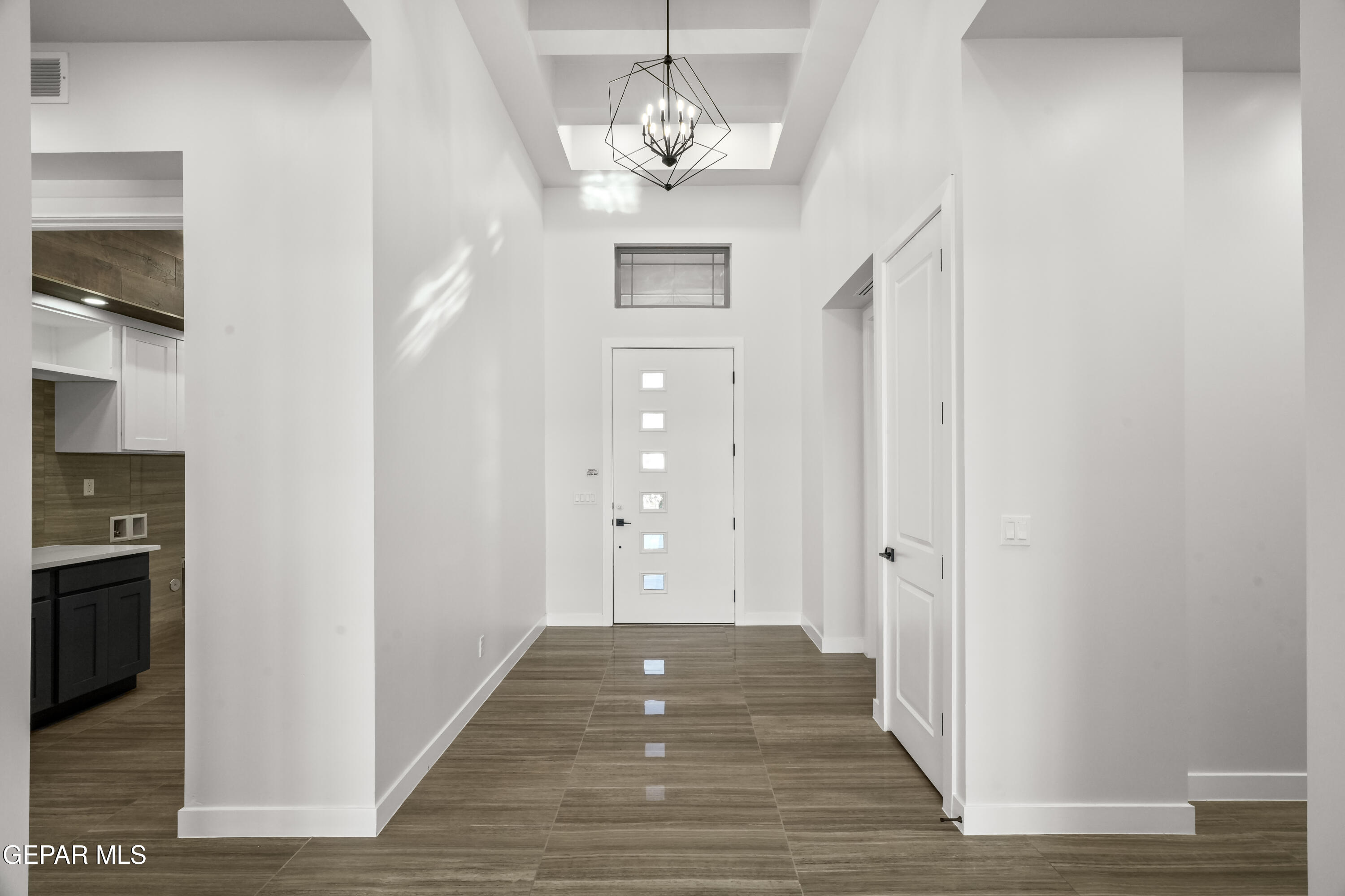 360 Rio De Jazmin Circle El Paso, TX 79932 - Photo 5 of 66 a view of a hallway with wooden floor and a chandelier