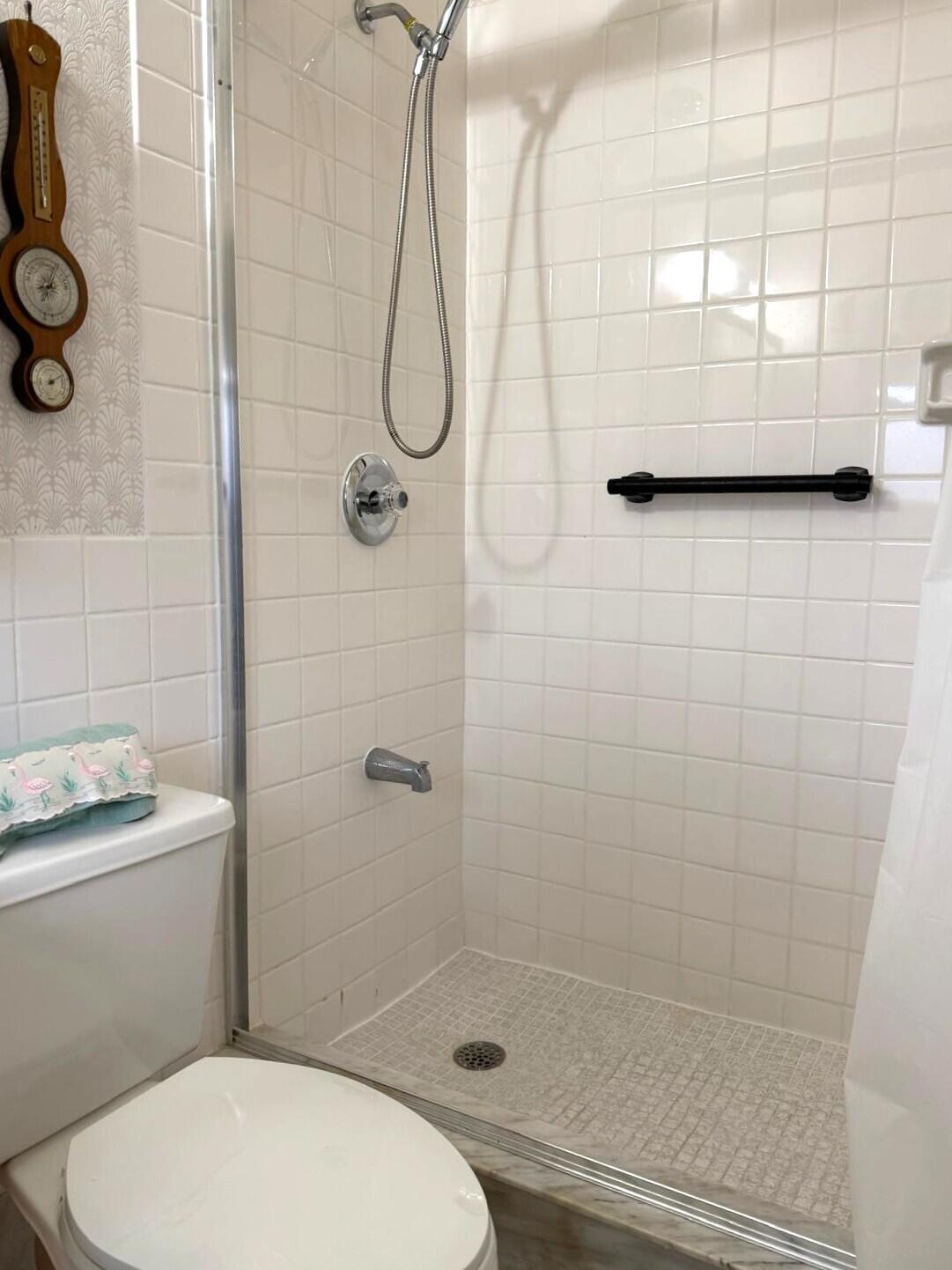 446 Bluebird Lane Delray Beach, FL 33445 - Photo 12 of 16 a bathroom with a toilet and shower