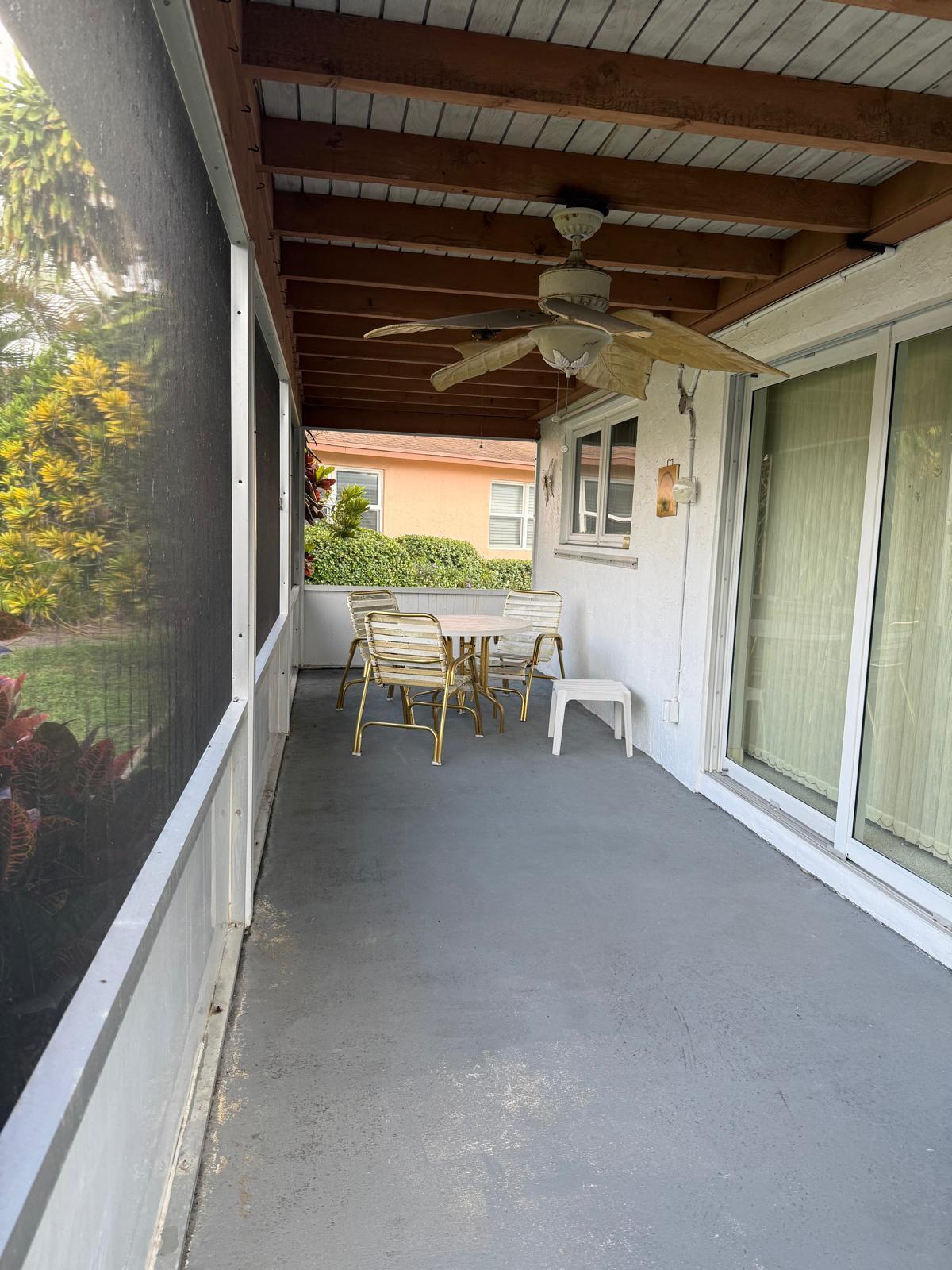 446 Bluebird Lane Delray Beach, FL 33445 - Photo 13 of 16 a view of a porch with chairs and backyard