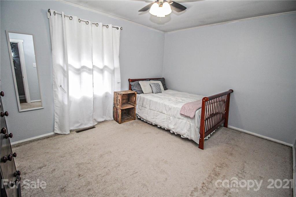 4227 Murrayhill Road Charlotte, NC 28209 - Photo 17 of 24 a bed sitting in a room next to a window