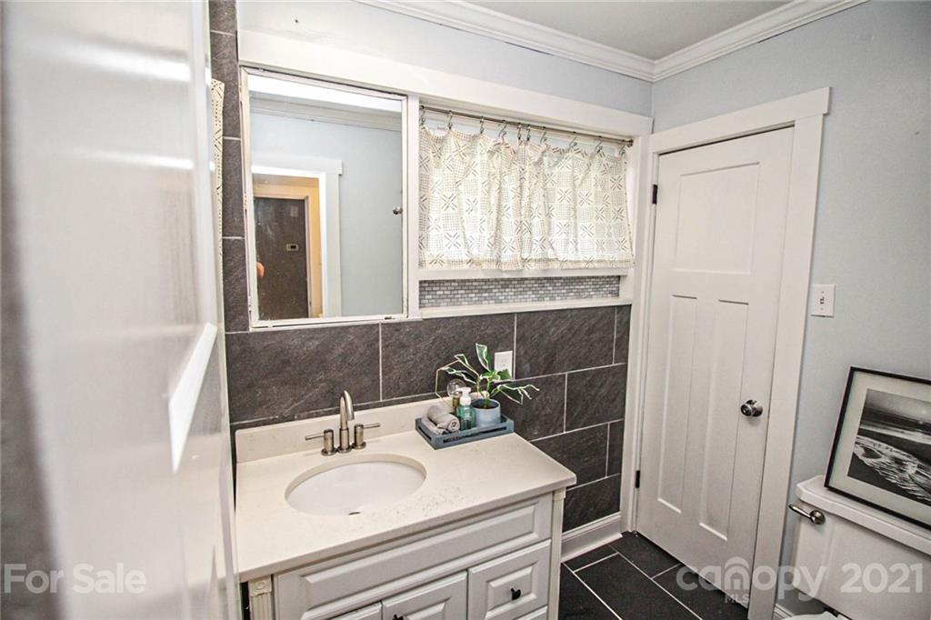 4227 Murrayhill Road Charlotte, NC 28209 - Photo 18 of 24 a bathroom with a sink and a mirror