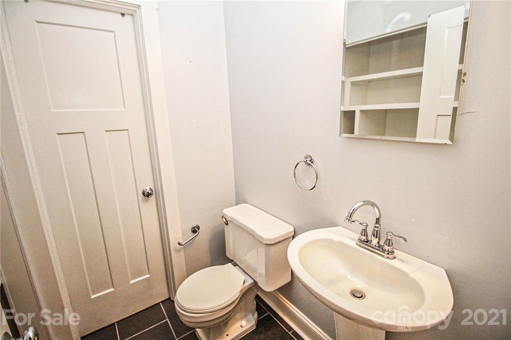 4227 Murrayhill Road Charlotte, NC 28209 - Photo 21 of 24 a bathroom with a sink and a mirror