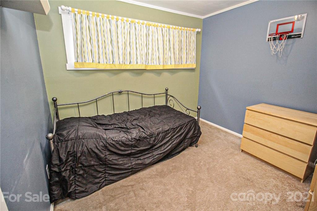 4227 Murrayhill Road Charlotte, NC 28209 - Photo 22 of 24 a bedroom with a bed and a window