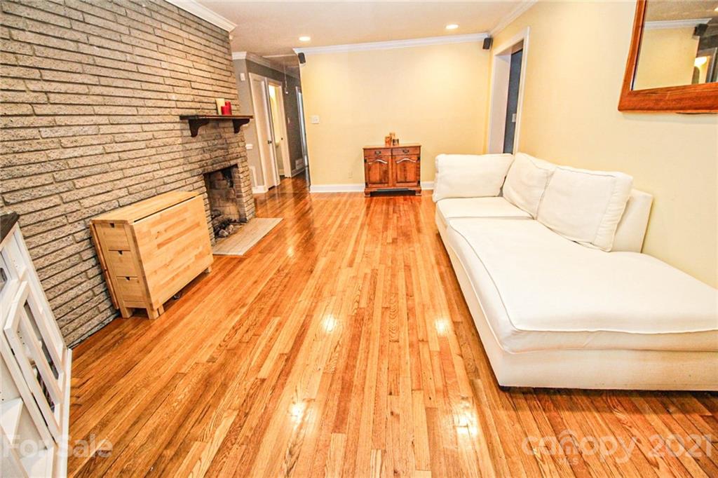 4227 Murrayhill Road Charlotte, NC 28209 - Photo 7 of 24 a balcony with couch and wooden floor