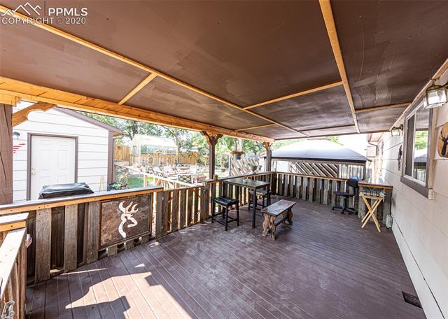 6727 Seneca Road Colorado Springs, CO 80915 - Photo 34 of 50 Custom-built 10'x20' wood deck with 20'x12' extended awning!