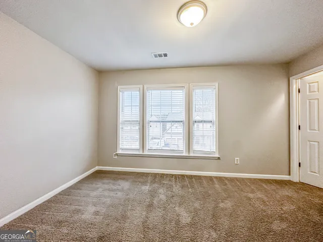 an empty room with a empty space and windows