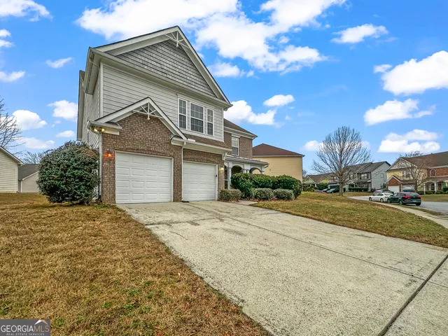 a front view of a house with a yard and garage