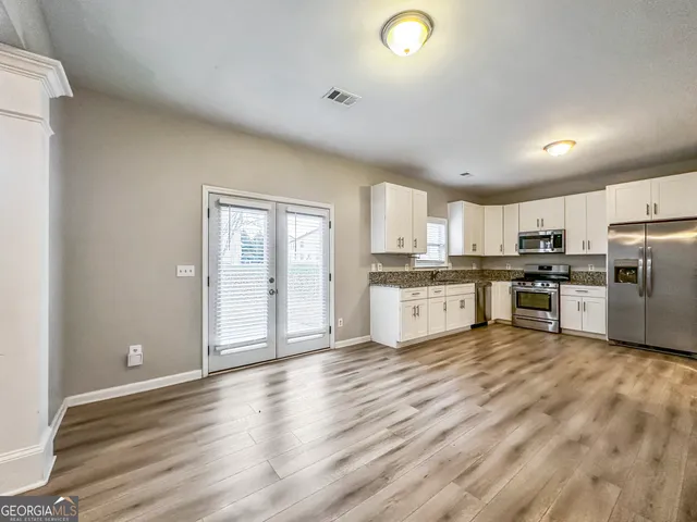 a view of kitchen with wooden floor