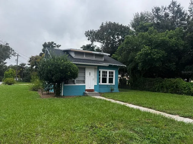 a front view of a house with a yard table and chairs