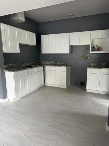 a kitchen with stainless steel appliances a refrigerator sink and cabinets