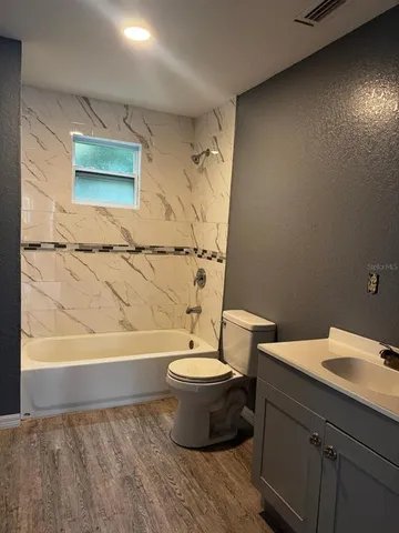 a bathroom with a bathtub and sink