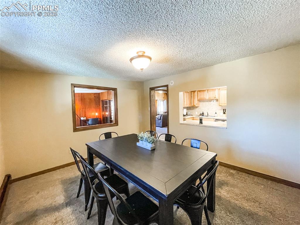 6025 Sioux Trail Cascade, CO 80809 - Photo 18 of 42 a view of a dining room with furniture