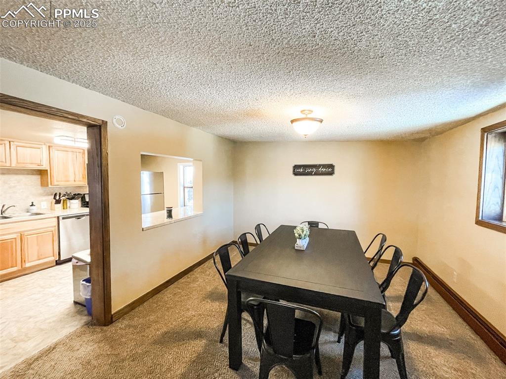 6025 Sioux Trail Cascade, CO 80809 - Photo 2 of 42 a view of a dining room with furniture and a window