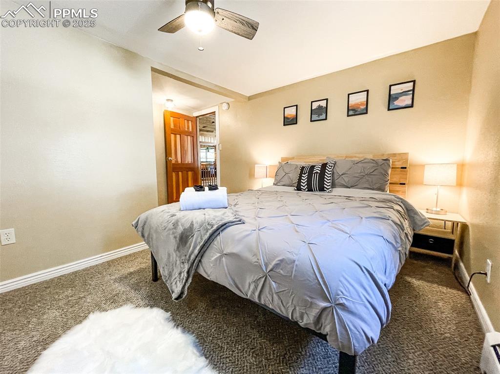 6025 Sioux Trail Cascade, CO 80809 - Photo 26 of 42 a bed sitting in a spacious bedroom next to a window