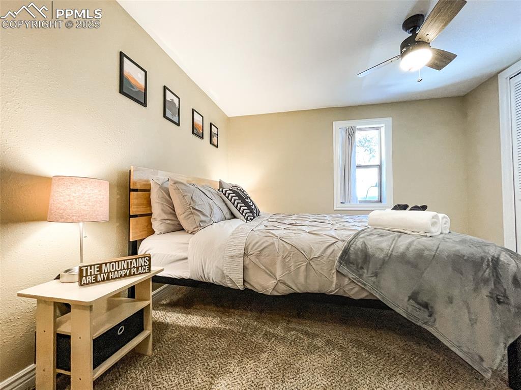 6025 Sioux Trail Cascade, CO 80809 - Photo 27 of 42 a bedroom with a bed and a night stand
