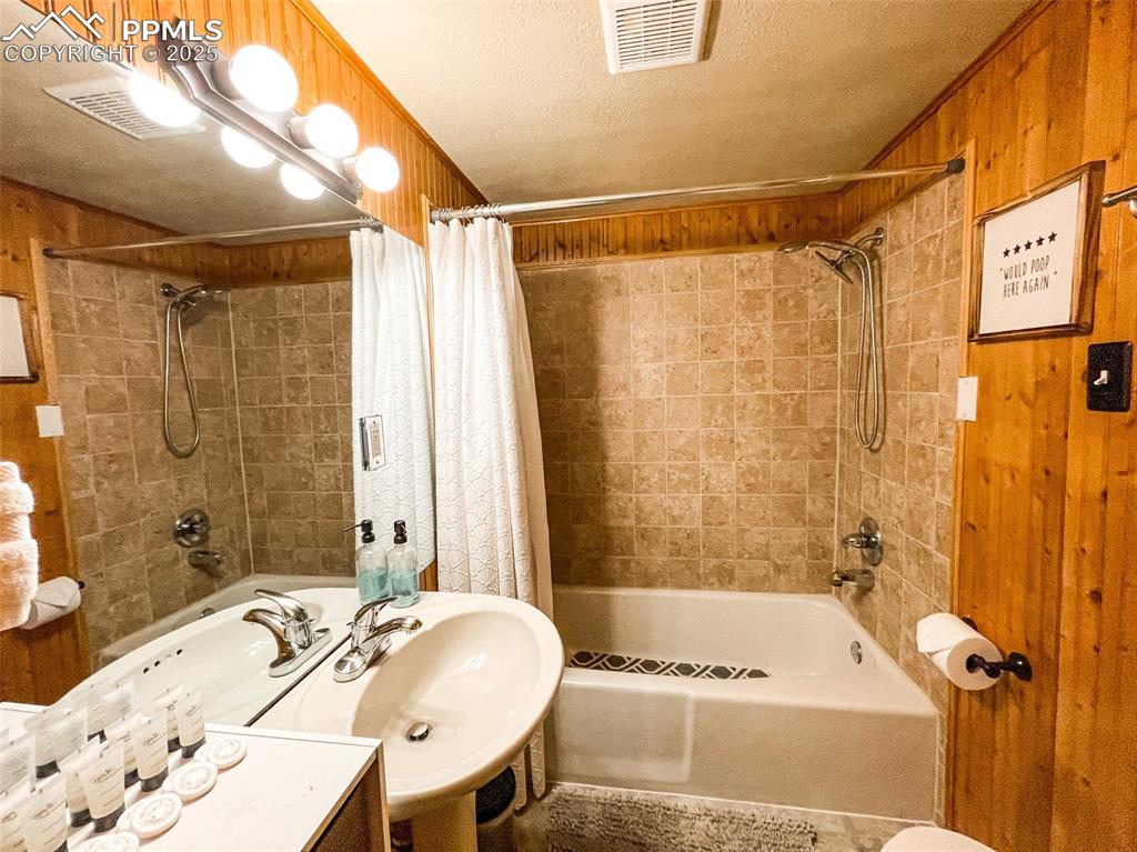 6025 Sioux Trail Cascade, CO 80809 - Photo 28 of 42 a bathroom with a sink a mirror a bathtub and shower