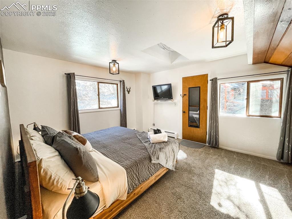 6025 Sioux Trail Cascade, CO 80809 - Photo 29 of 42 a bedroom with a large bed and a window