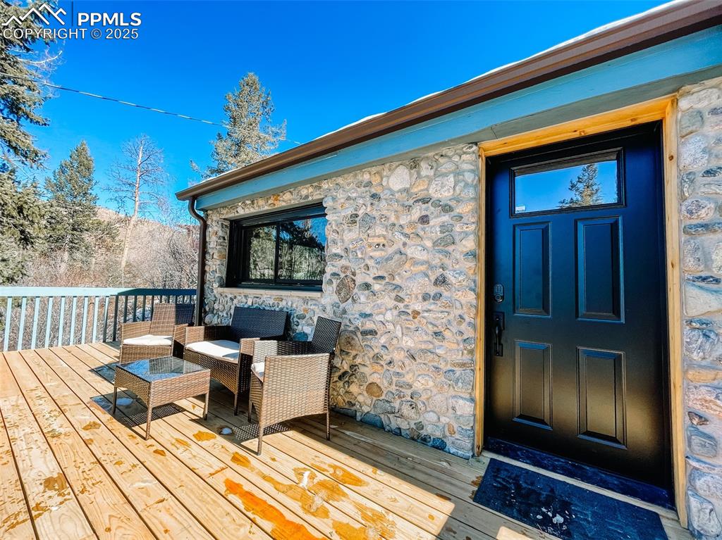 6025 Sioux Trail Cascade, CO 80809 - Photo 3 of 42 a outdoor space with patio the couches and a potted plant on the table