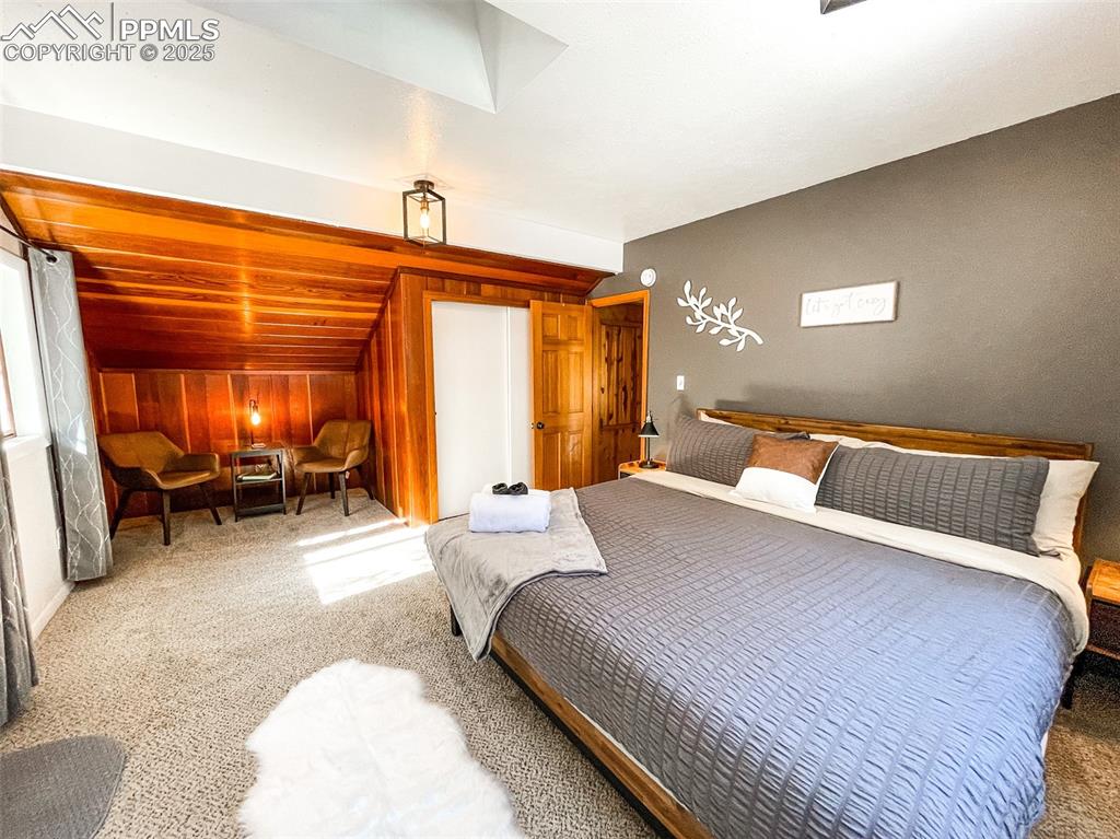 6025 Sioux Trail Cascade, CO 80809 - Photo 31 of 42 a bedroom with a bed and a chair