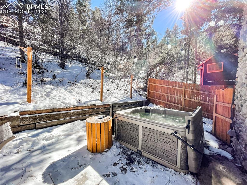 6025 Sioux Trail Cascade, CO 80809 - Photo 40 of 42 a view of a backyard with chairs and a fire pit