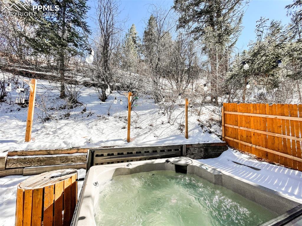 6025 Sioux Trail Cascade, CO 80809 - Photo 41 of 42 a view of a swimming pool with a bench and trees in the background
