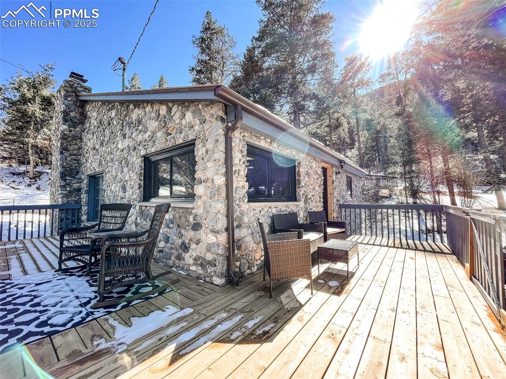 6025 Sioux Trail Cascade, CO 80809 - Photo 5 of 42 a view of a patio with wooden floor