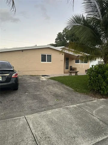 a view of a car parked front of a house