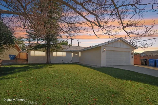 a view of a yard in front of a house with large trees