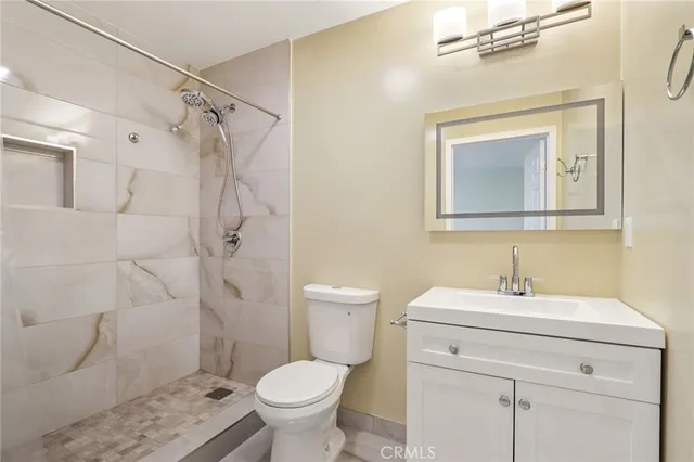 a view of a room with wooden floor and white walls