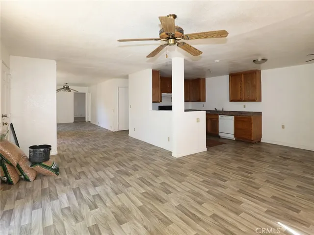 a kitchen with granite countertop a sink cabinets and stainless steel appliances