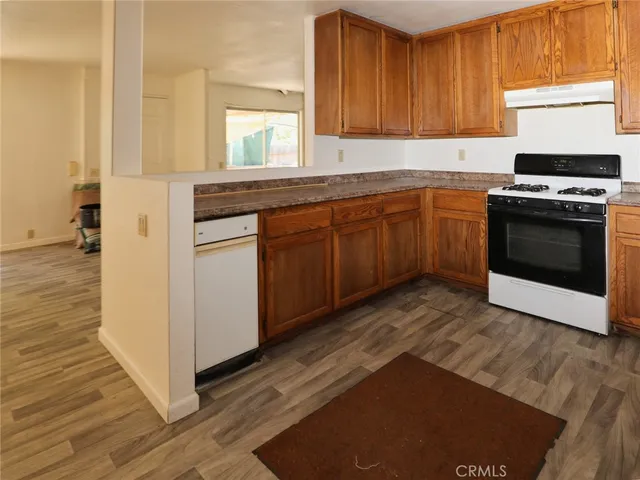 a view of empty room with wooden floor and floor to ceiling window