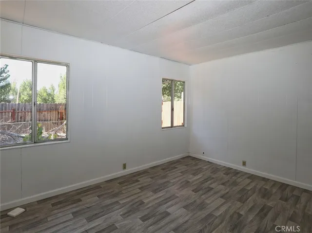 a bedroom with a large bed and potted plant