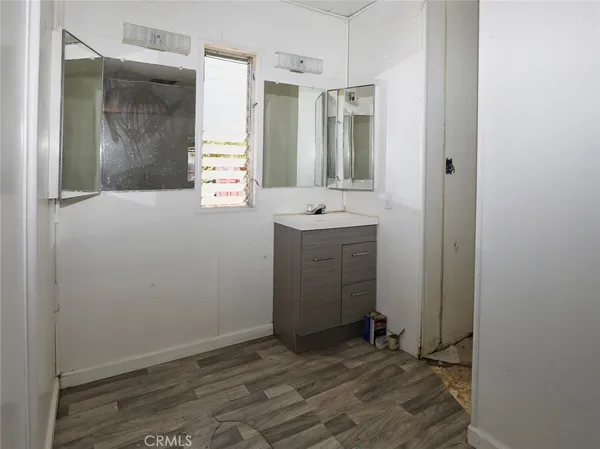 a bathroom with a granite countertop toilet sink and mirror